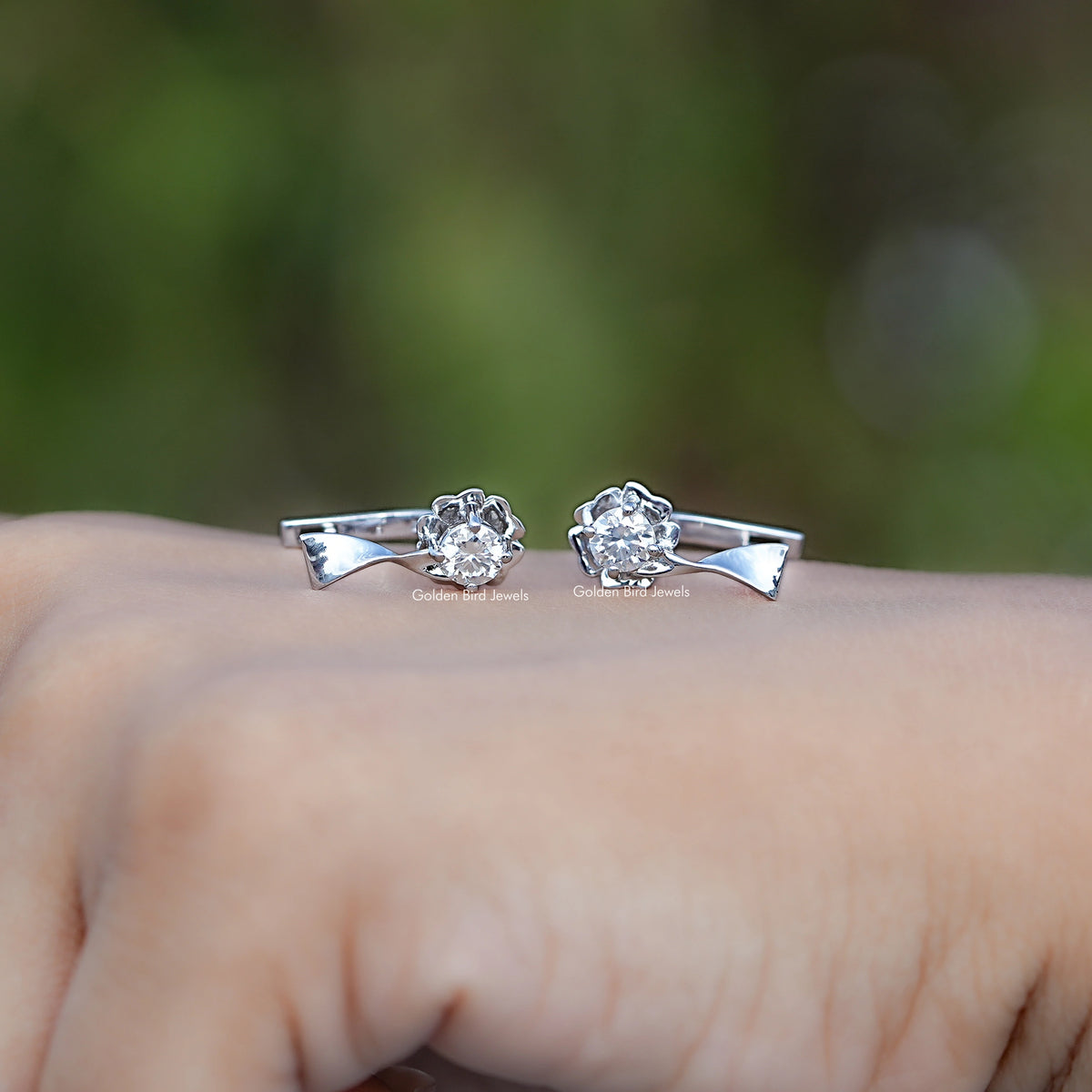 Pair of silver moissanite cluster earrings with triangular settings, side front view