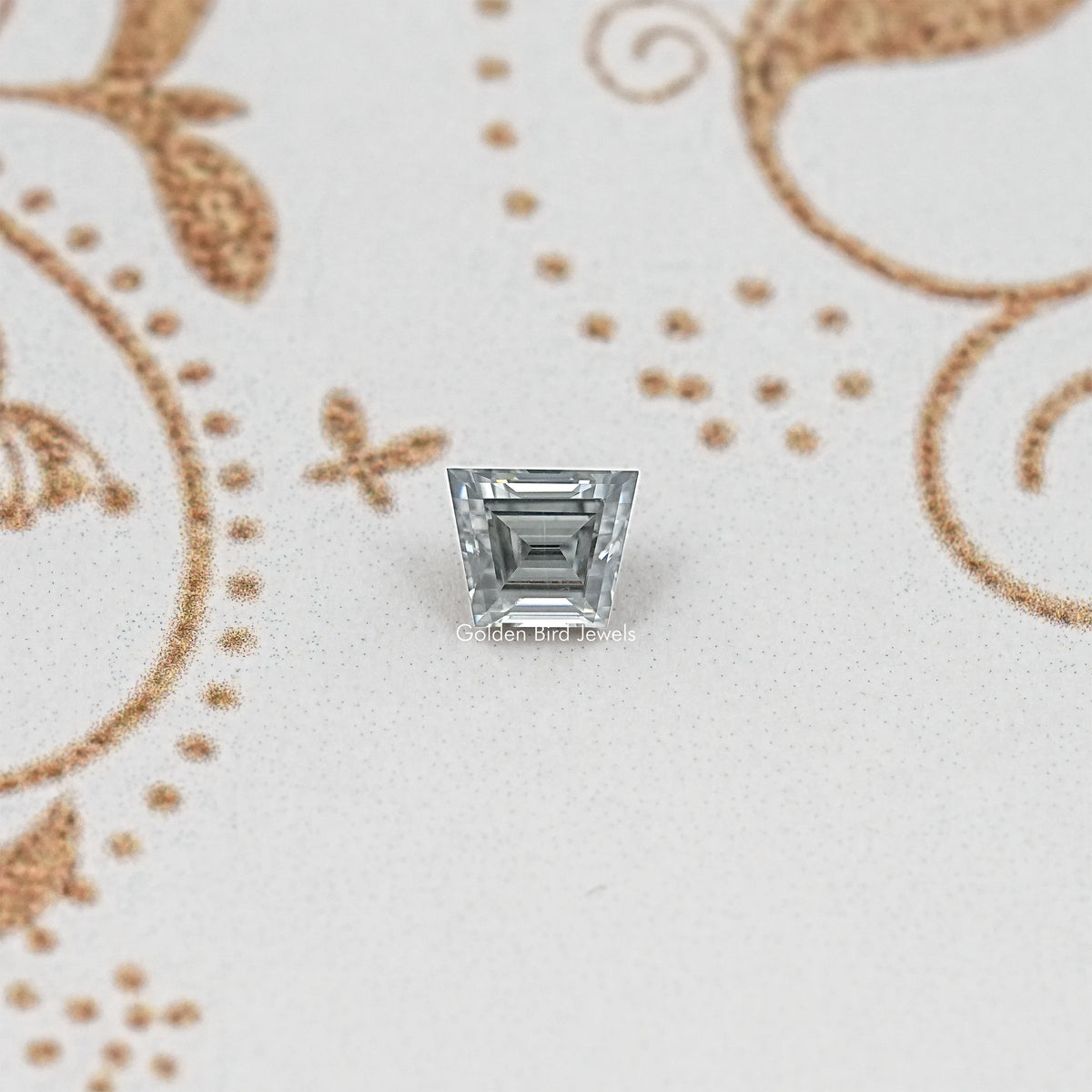 Gray trapezoid-cut moissanite gemstone with step facets and reflective silver sparkle