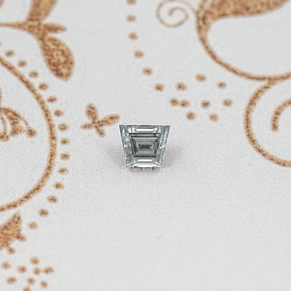 Gray trapezoid-cut moissanite gemstone with step facets and reflective silver sparkle