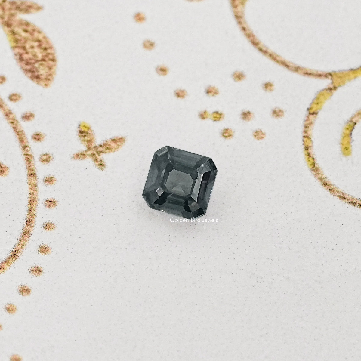 Gray Asscher-cut moissanite gemstone, loose center stone on a light background