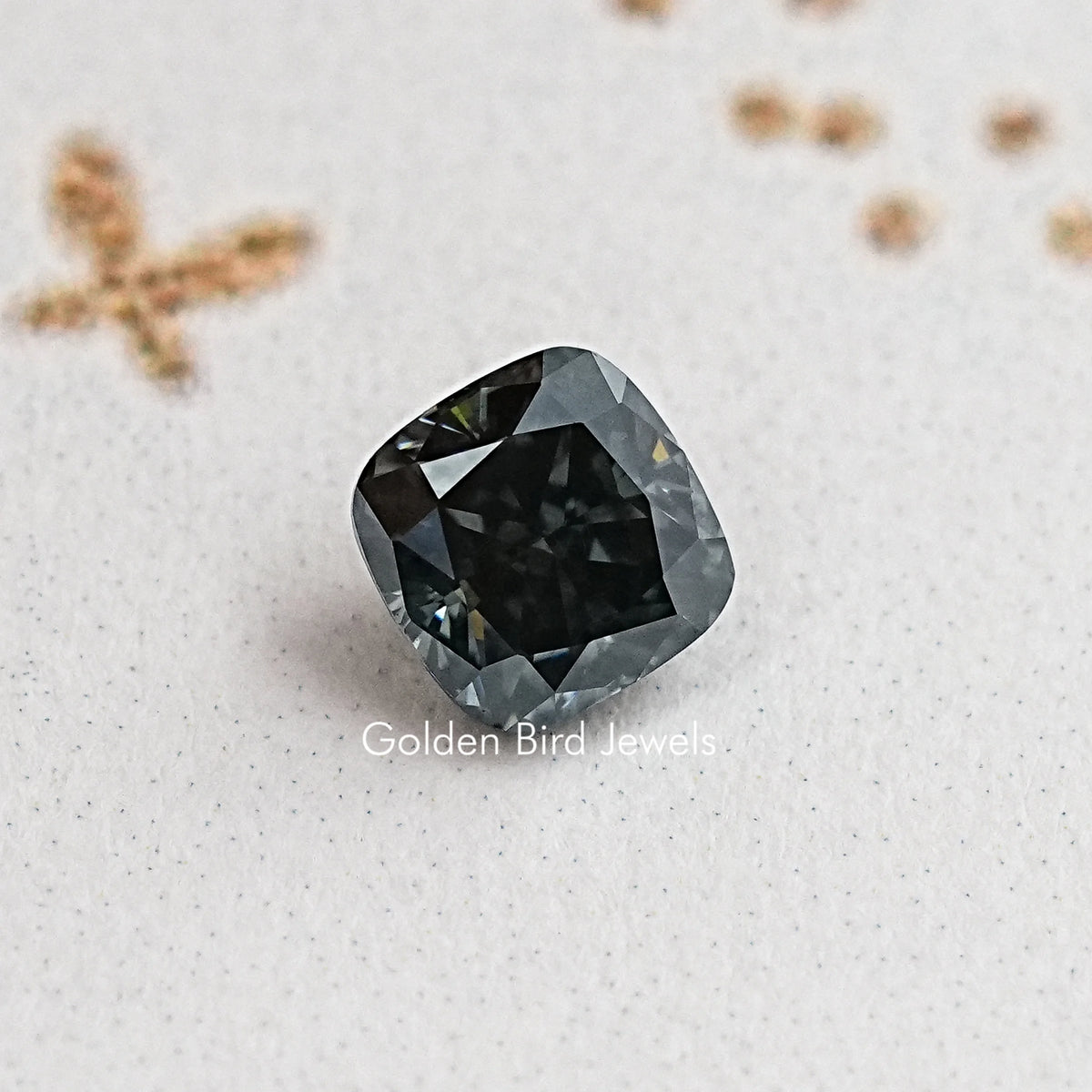 Cushion-cut moissanite gemstone, dark gray/black cushion with prismatic facets