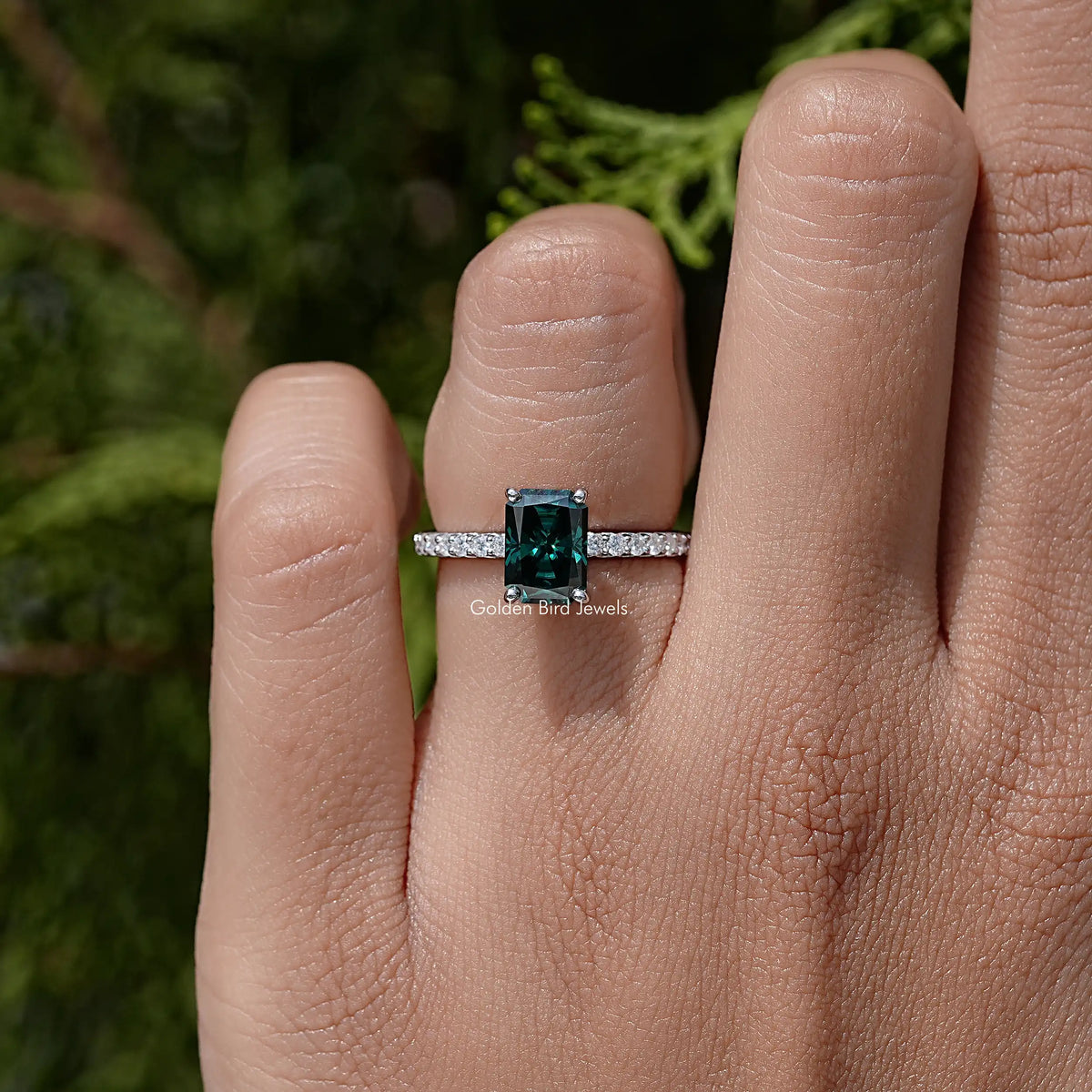 Sterling silver band ring with small accent stones and green moissanite square top