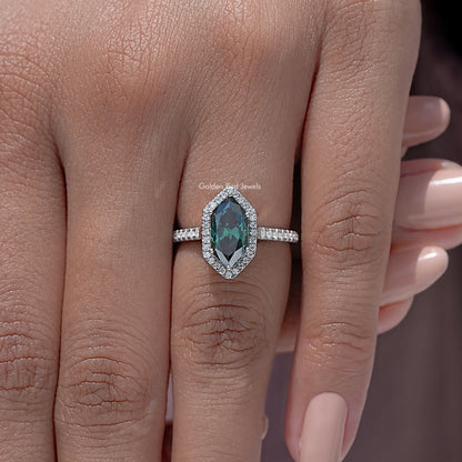 Sterling silver marquise halo accent ring close-up on finger with green stone