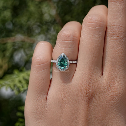 Green pear moissanite halo ring in sterling silver band with prong-set side sparkle