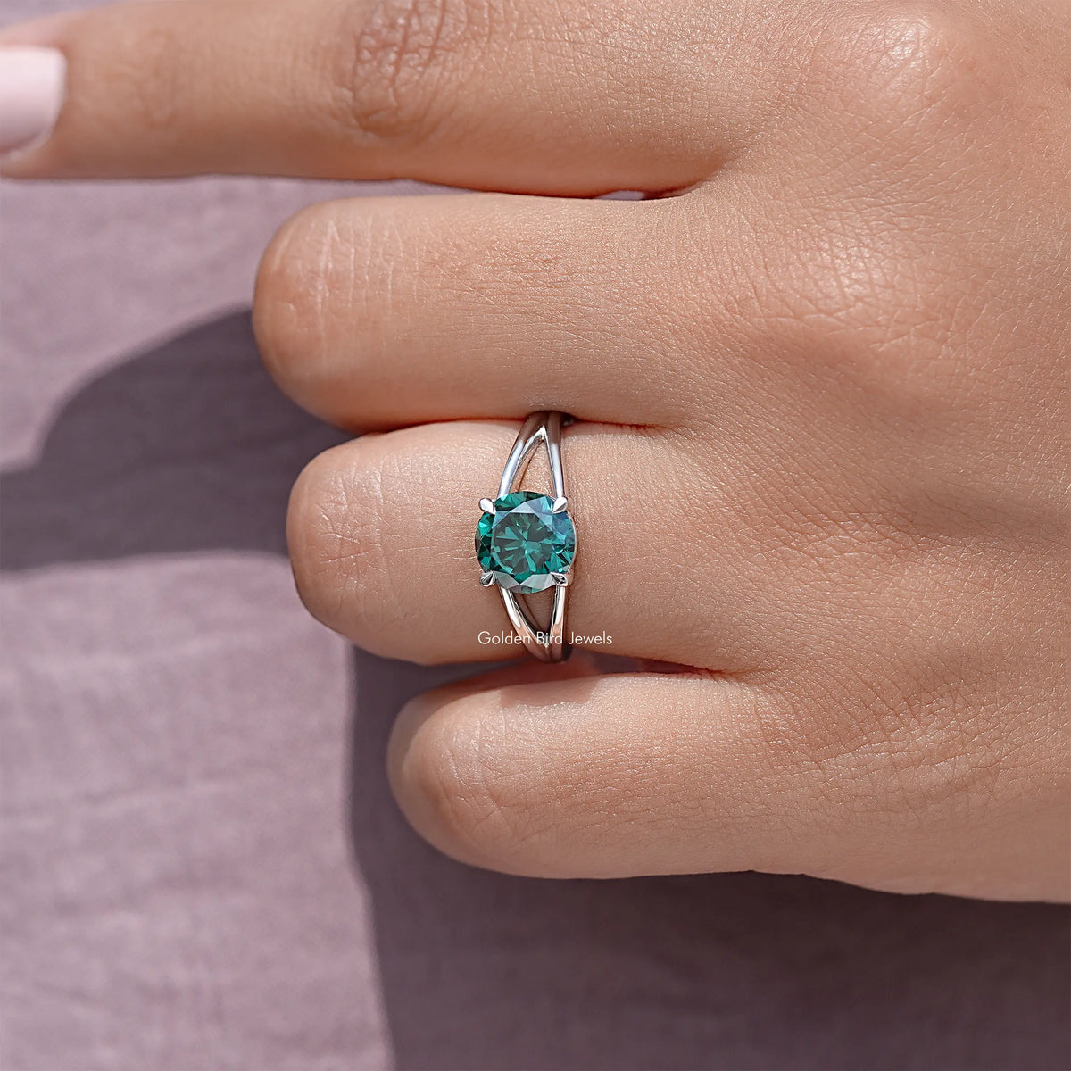 Sterling silver split-shank ring with round teal moissanite center, side profile