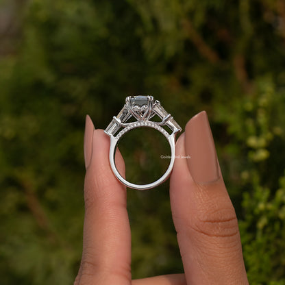 Sterling silver ring viewed from above with rectangular center stone and prong-set accents