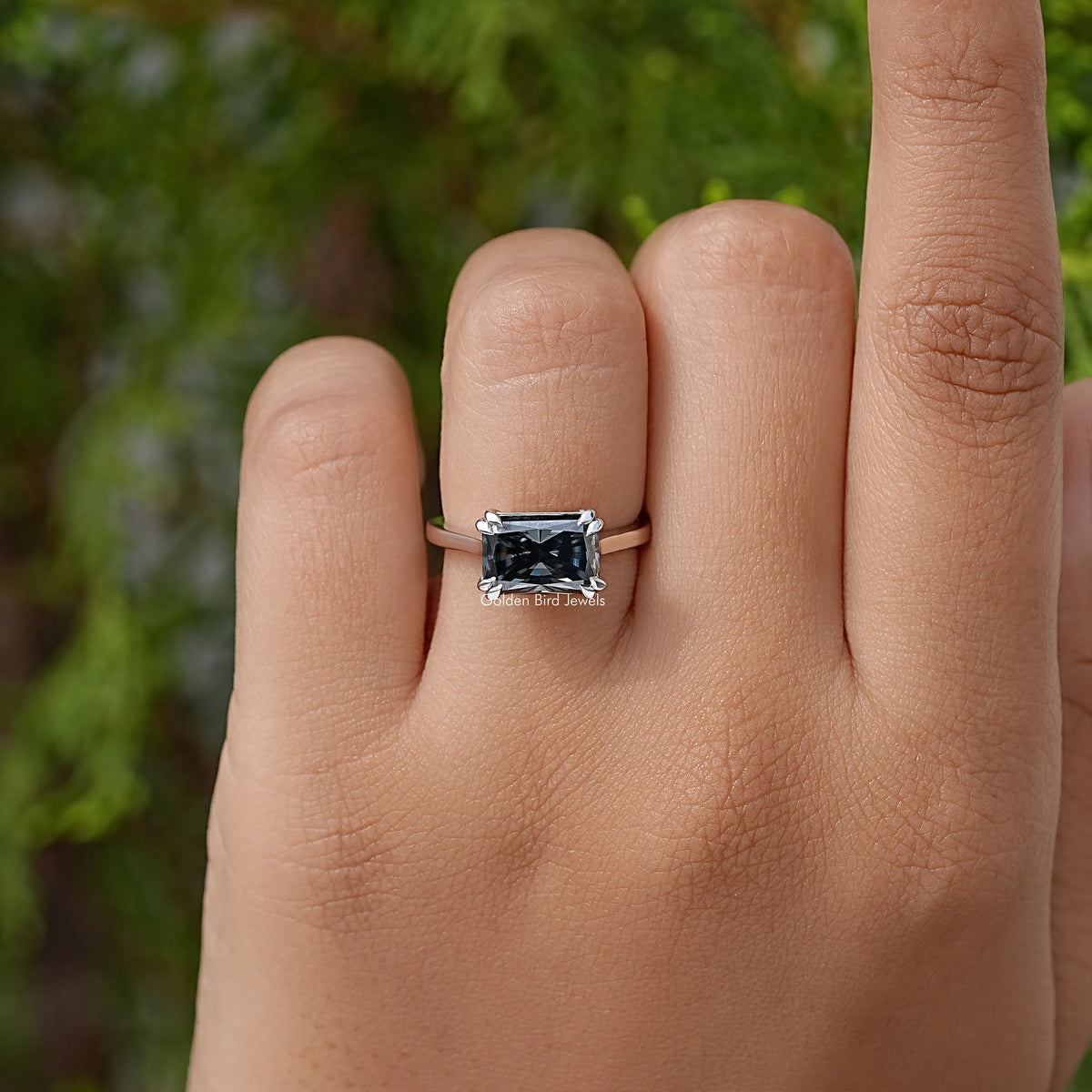 Silver band solitaire engagement ring with small square black center stone