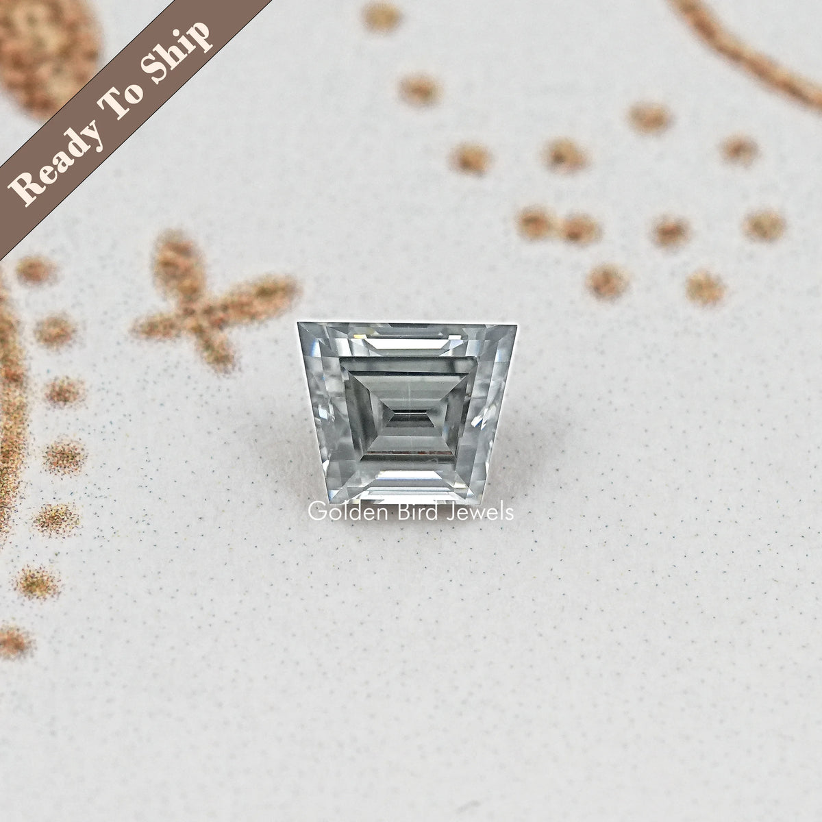 Gray trapezoid-cut moissanite gemstone featuring stacked rectangular facet cuts