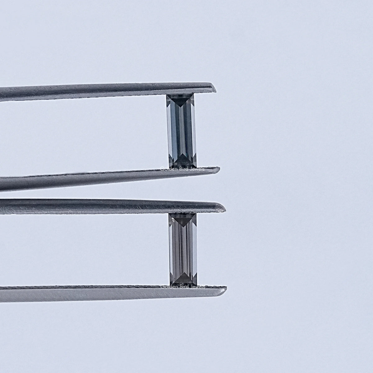 In Tweezer View Of Grey Baguette Cut Loose Moissanite Pair