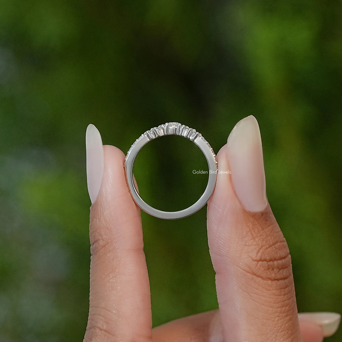 Silver moissanite eternity band ring with prong-set pear-cut white stones, top view