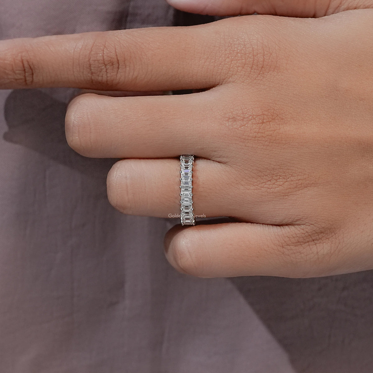 Silver baguette-cut half-eternity ring viewed on finger, slim side profile