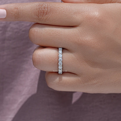 Close-up side view of half eternity moissanite band with clear round-cut stones