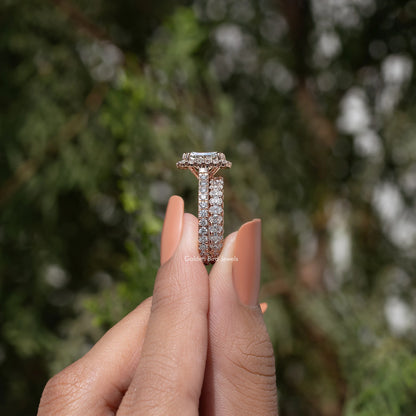 Radiant cut lab diamond halo bridal ring set held between fingers