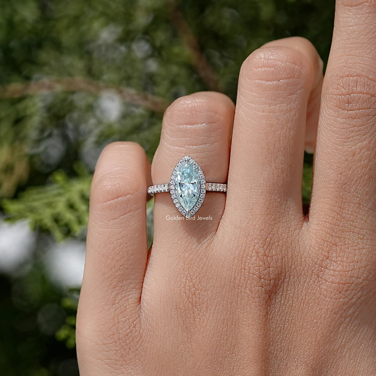 Marquise-cut blue moissanite ring with pavé band