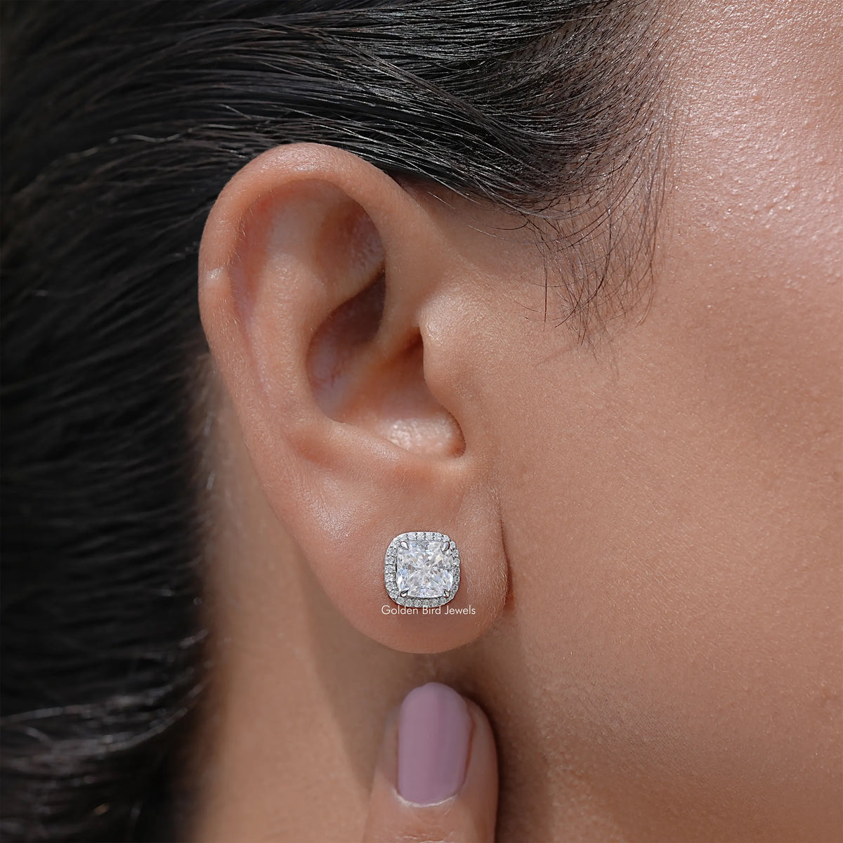 Cushion-cut halo stud earrings with round-edge settings, side view on ear