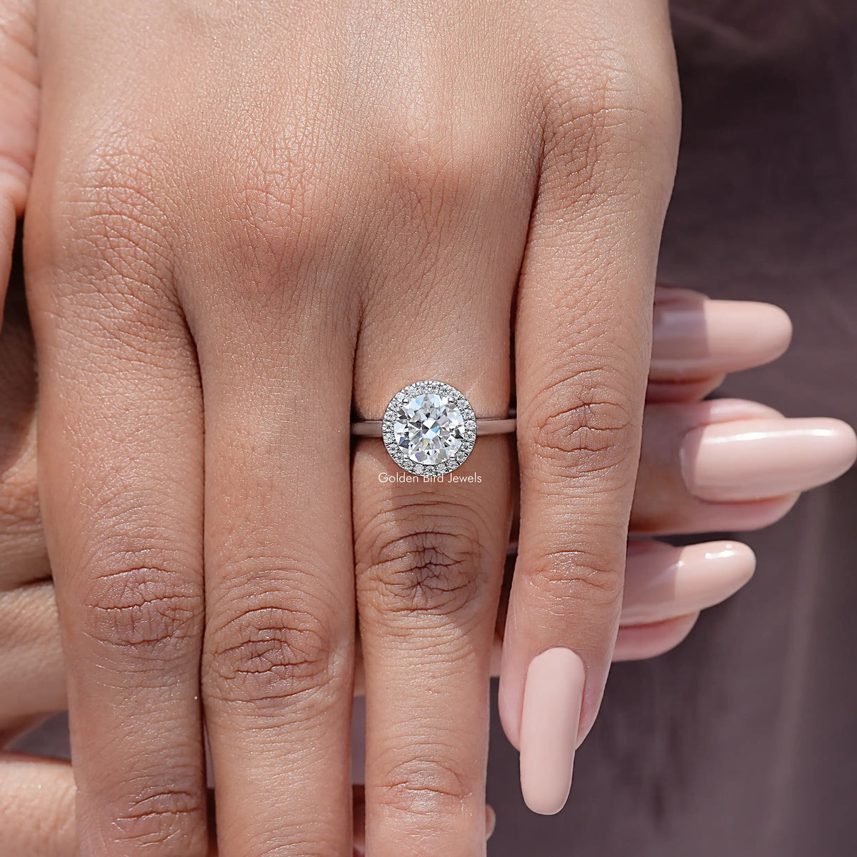 Round halo moissanite ring on hand, 925 sterling silver band