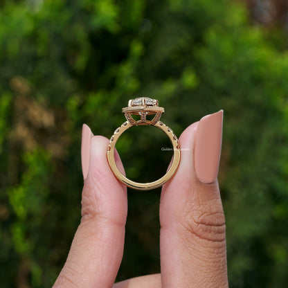 Gold-toned marquise-cut halo engagement ring with small round side stones