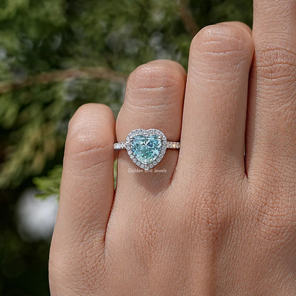 Heart-cut blue gemstone wedding ring in sterling silver, on finger