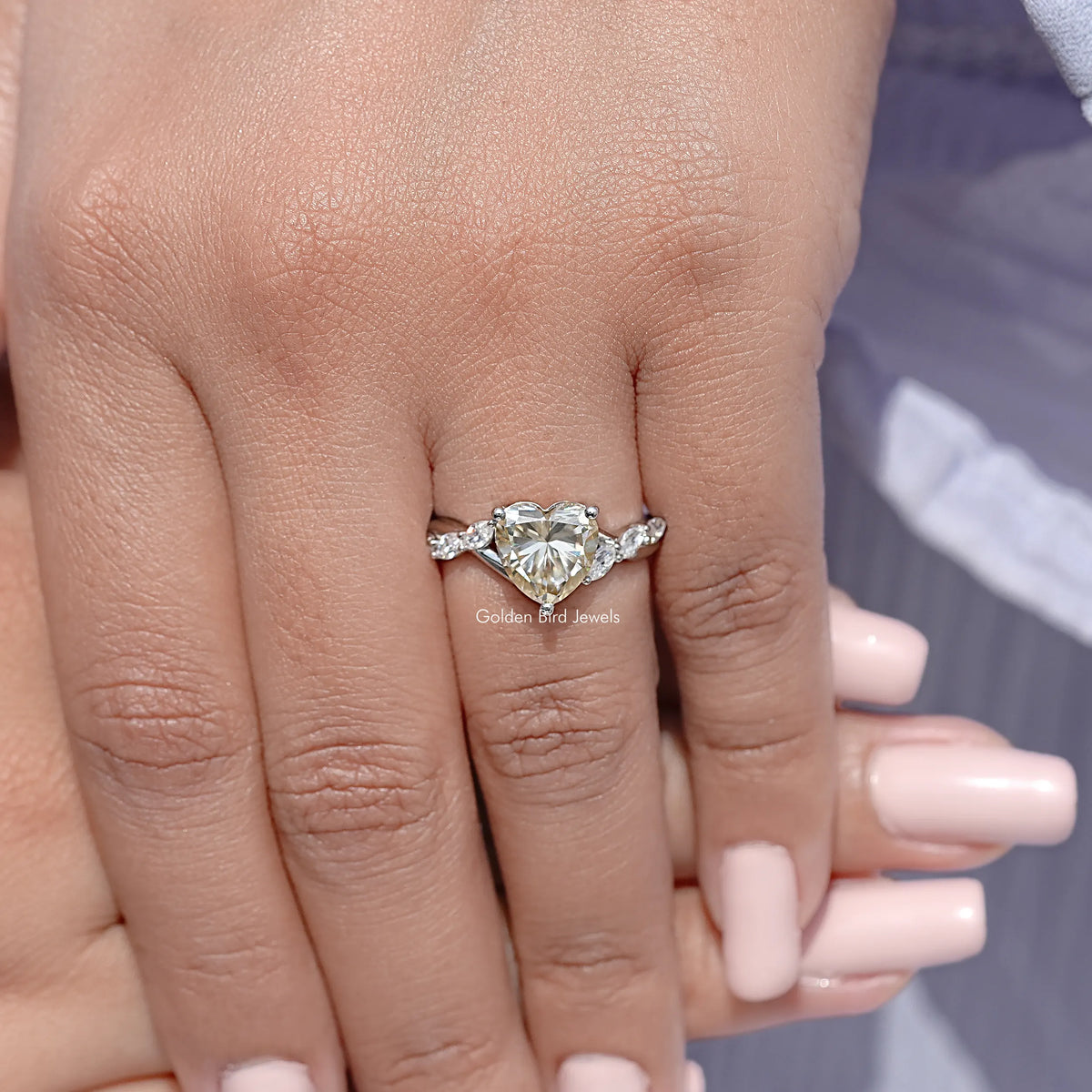Sterling silver heart-center ring with small side stones on a slim band