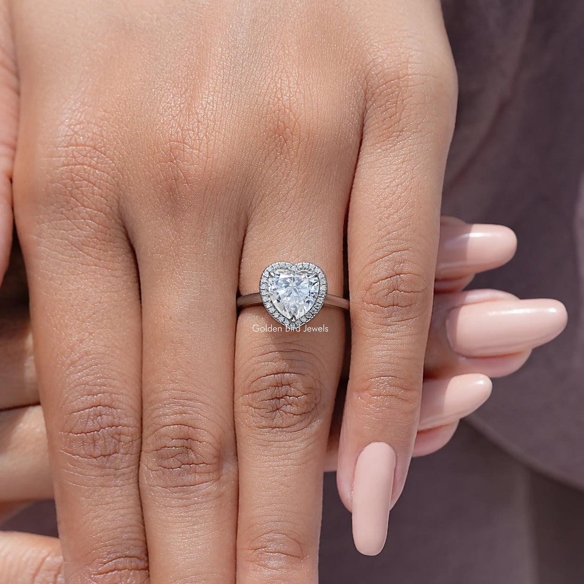 Heart-cut moissanite halo anniversary ring on hand, heart-shaped stone with sparkly halo
