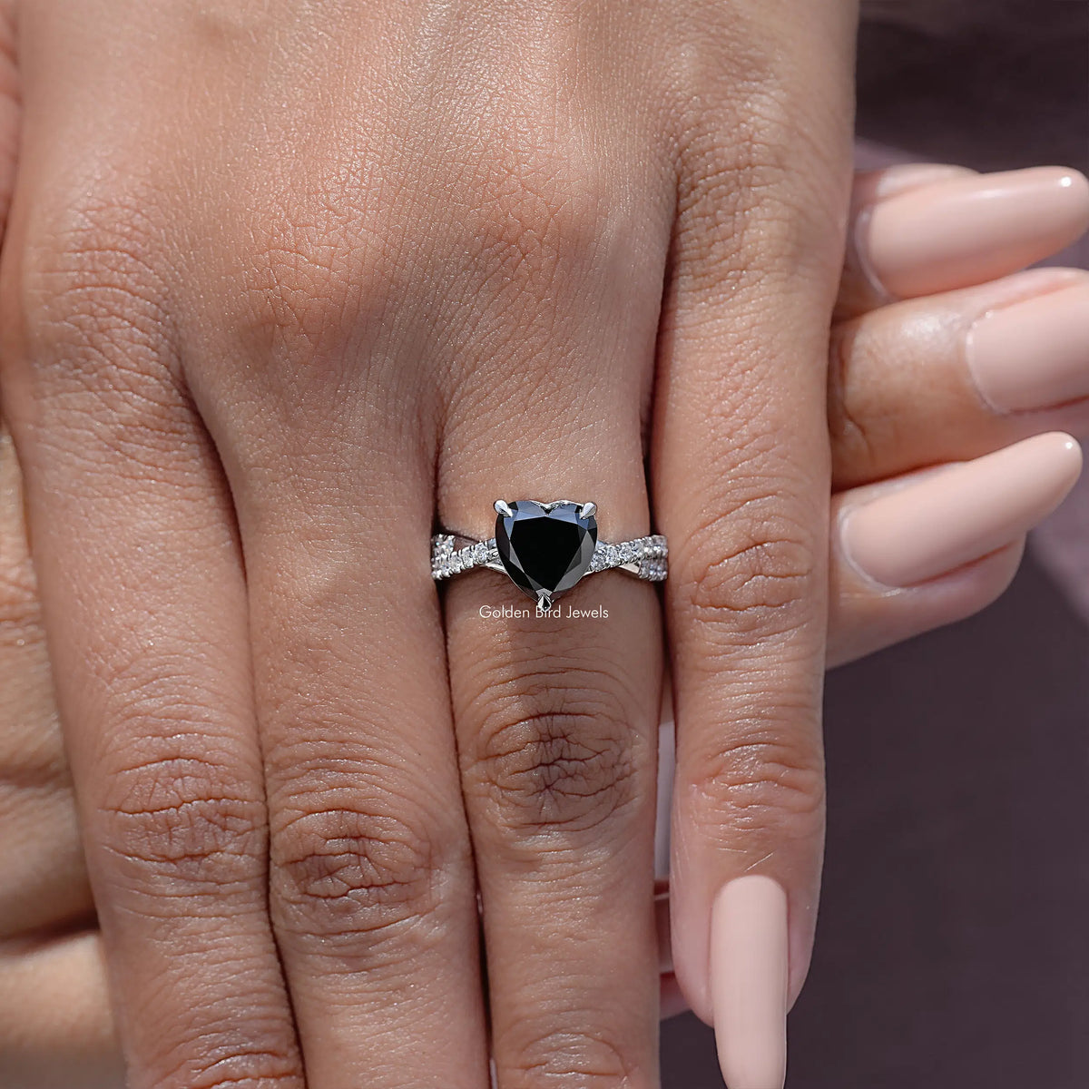 Black heart moissanite twisted accent band on a hand