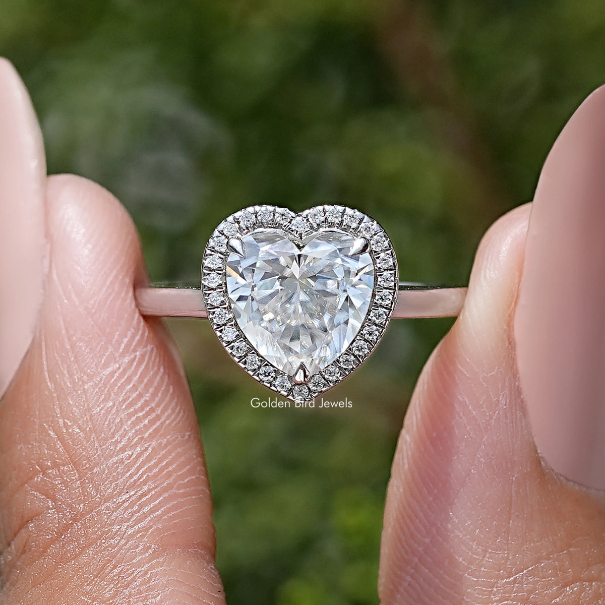 Heart-cut moissanite heart center with sparkling halo on ring band