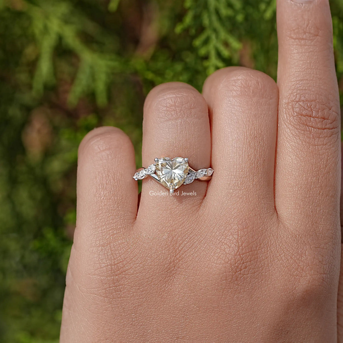 Heart-shaped gemstone ring in sterling silver with floral-style side stone settings