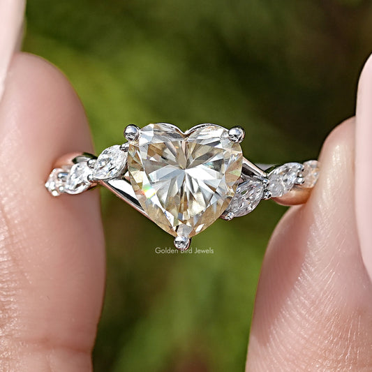 Silver wedding ring with heart-shaped center stone and marquise floral side stones