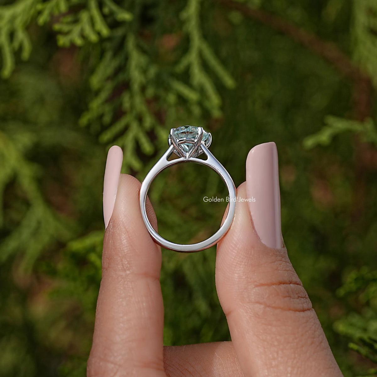 Sterling silver solitaire ring back view, prongs around faceted center stone