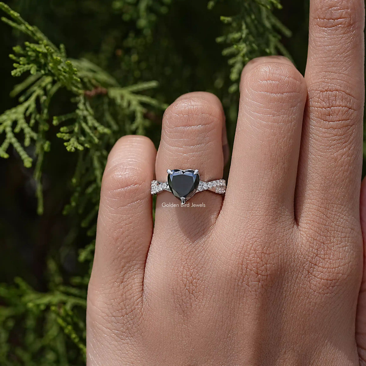 Black heart moissanite twisted accent band on a hand