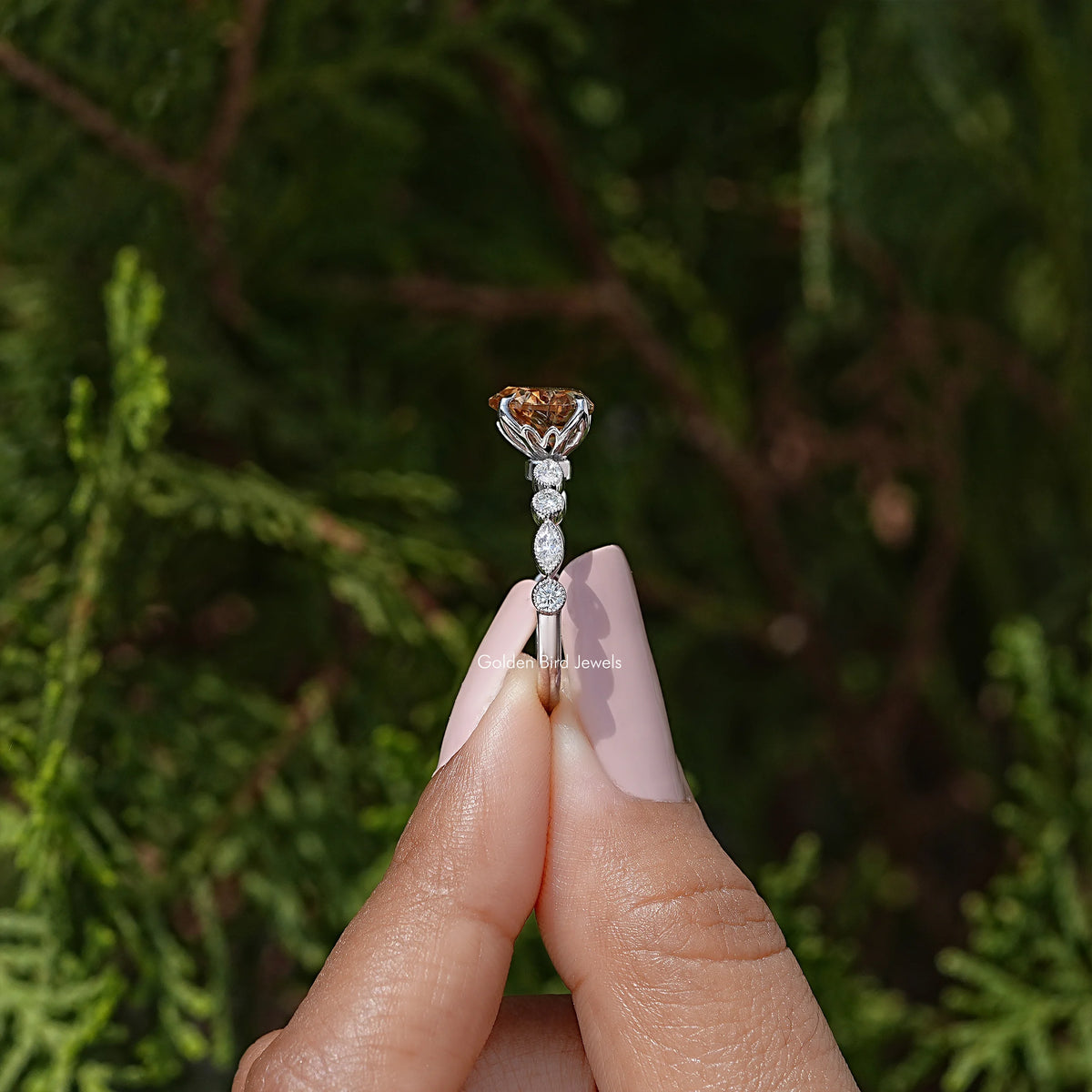 Side view of heart-shaped moissanite wedding ring with prong-set center stone