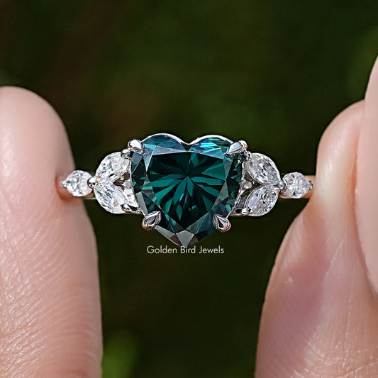 Close-up: green moissanite center with halo and round side stones on sterling silver