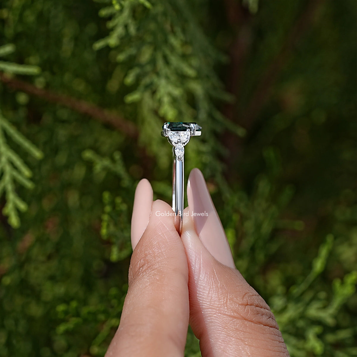 925 sterling silver ring with prong-set green moissanite center and small halo stones