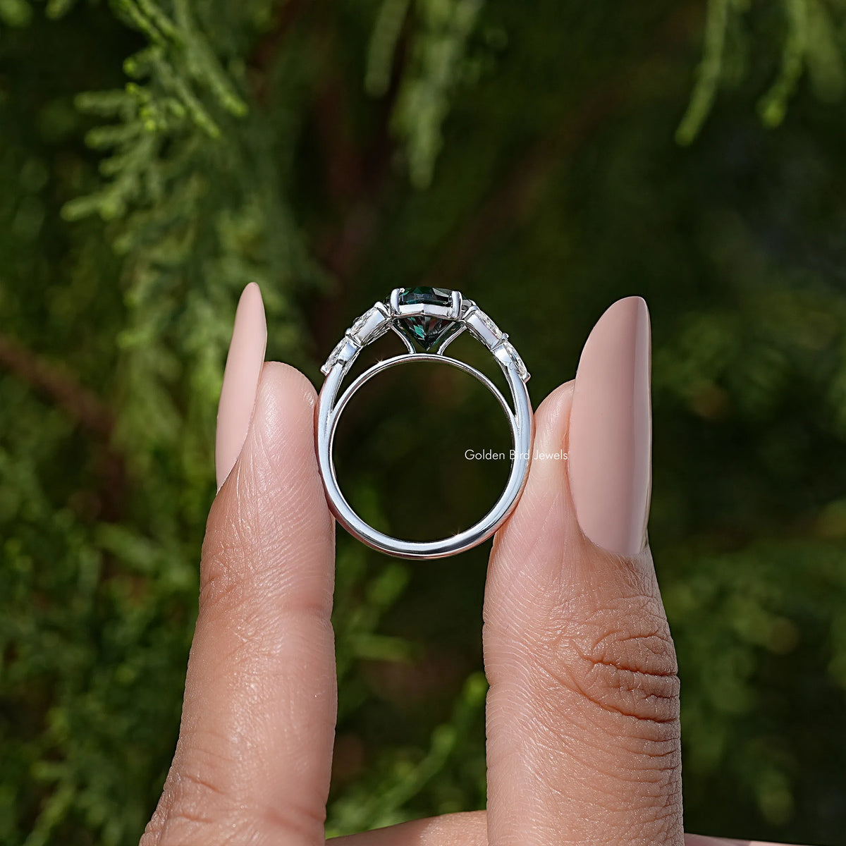 Back view of 925 sterling silver ring with green moissanite and halo setting