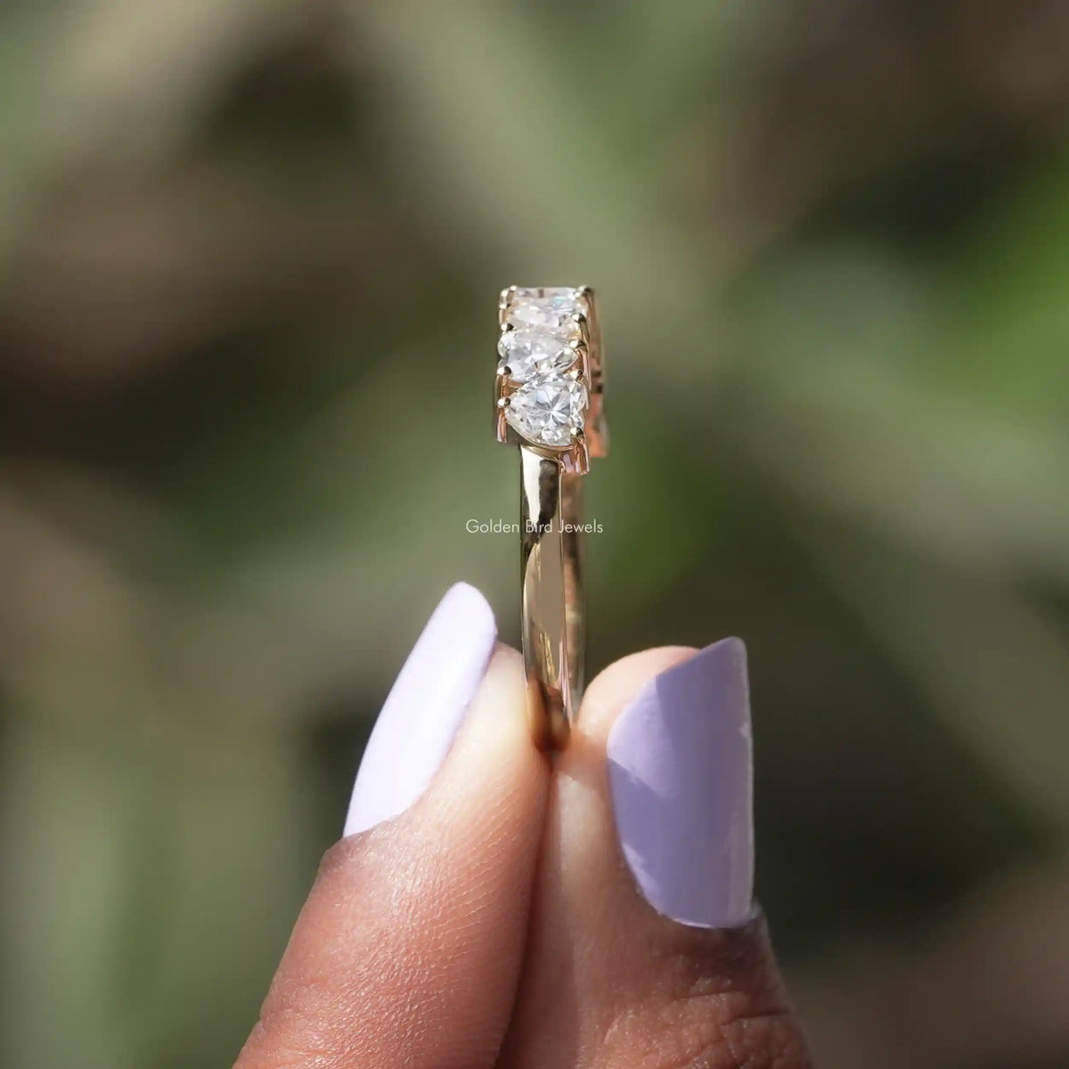 Single heart-cut moissanite stone prong-set on a gold-toned band