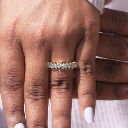Close view of moissanite half eternity ring with stacked stones on the finger