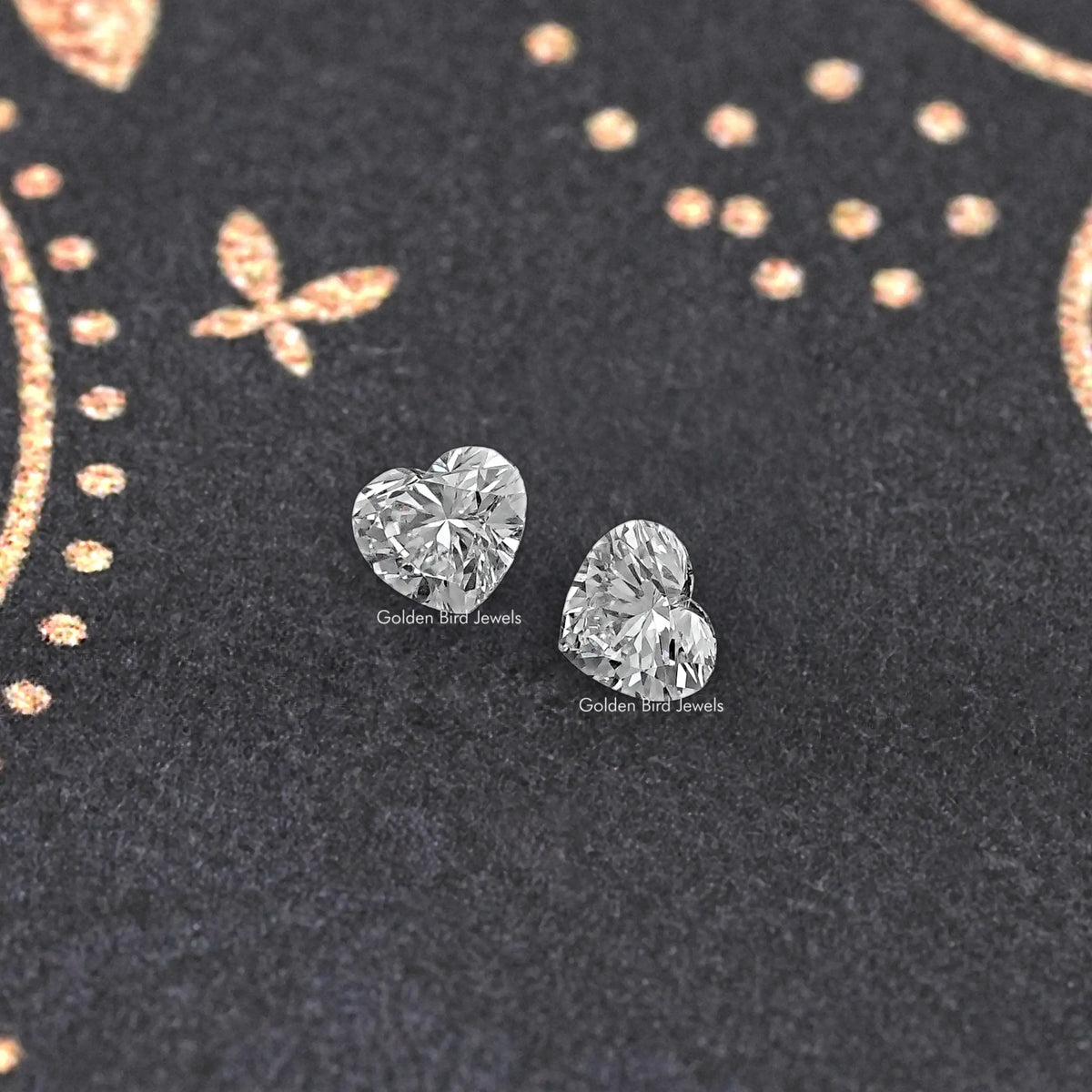 Heart-cut loose diamond pair, one tilted heart and one facing forward