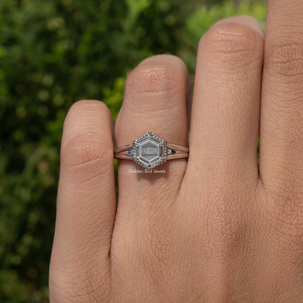 Hexagon-cut moissanite ring on hand, slim band with prong-set hexagon center stone