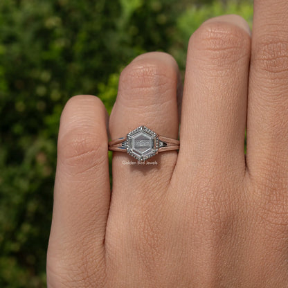 Hexagon-cut moissanite ring on hand, slim band with prong-set hexagon center stone