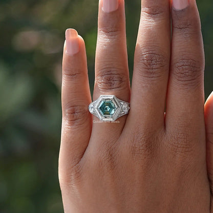 925 sterling silver engagement ring with teal hexagon moissanite center on finger