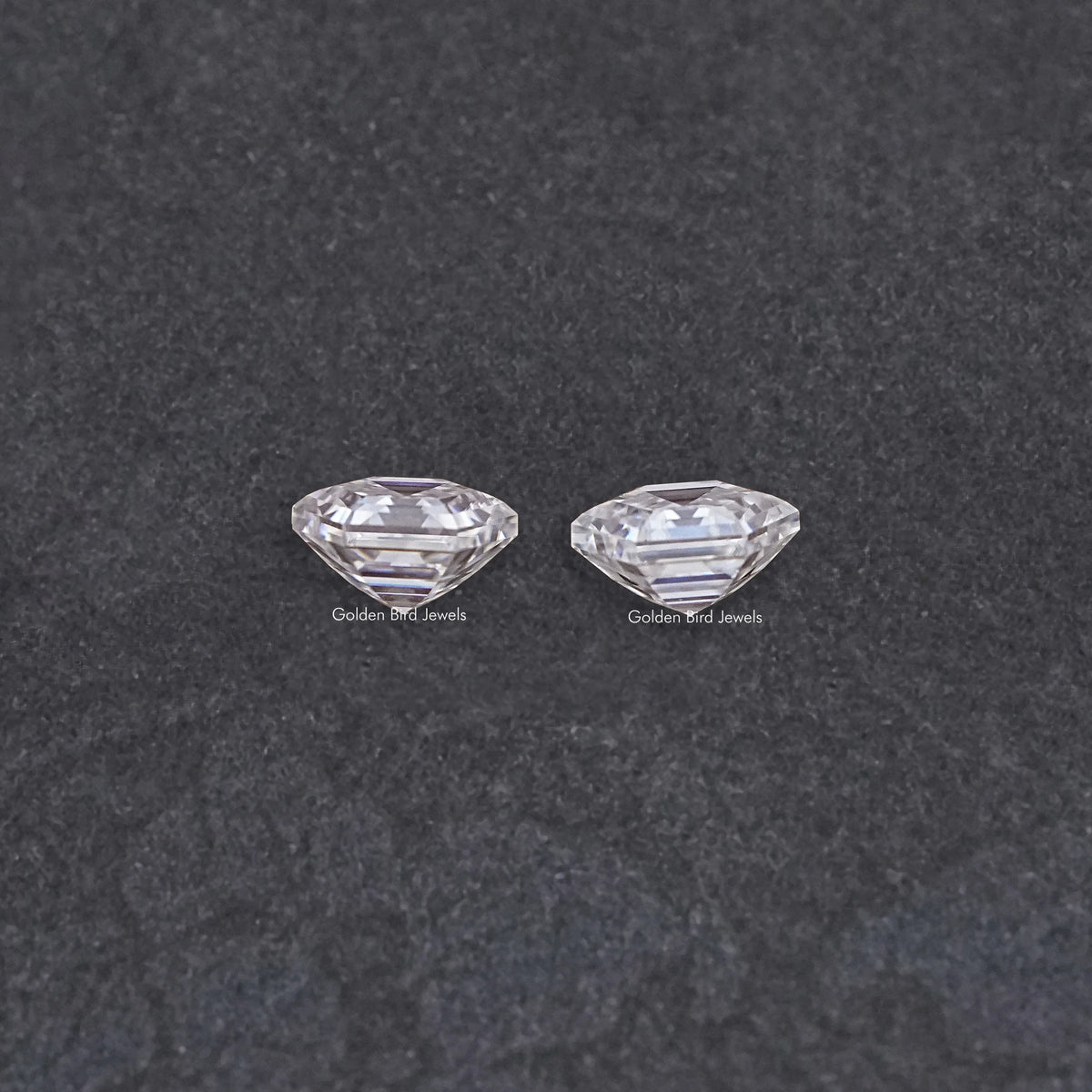 Two clear faceted moissanite stones, loose pairing