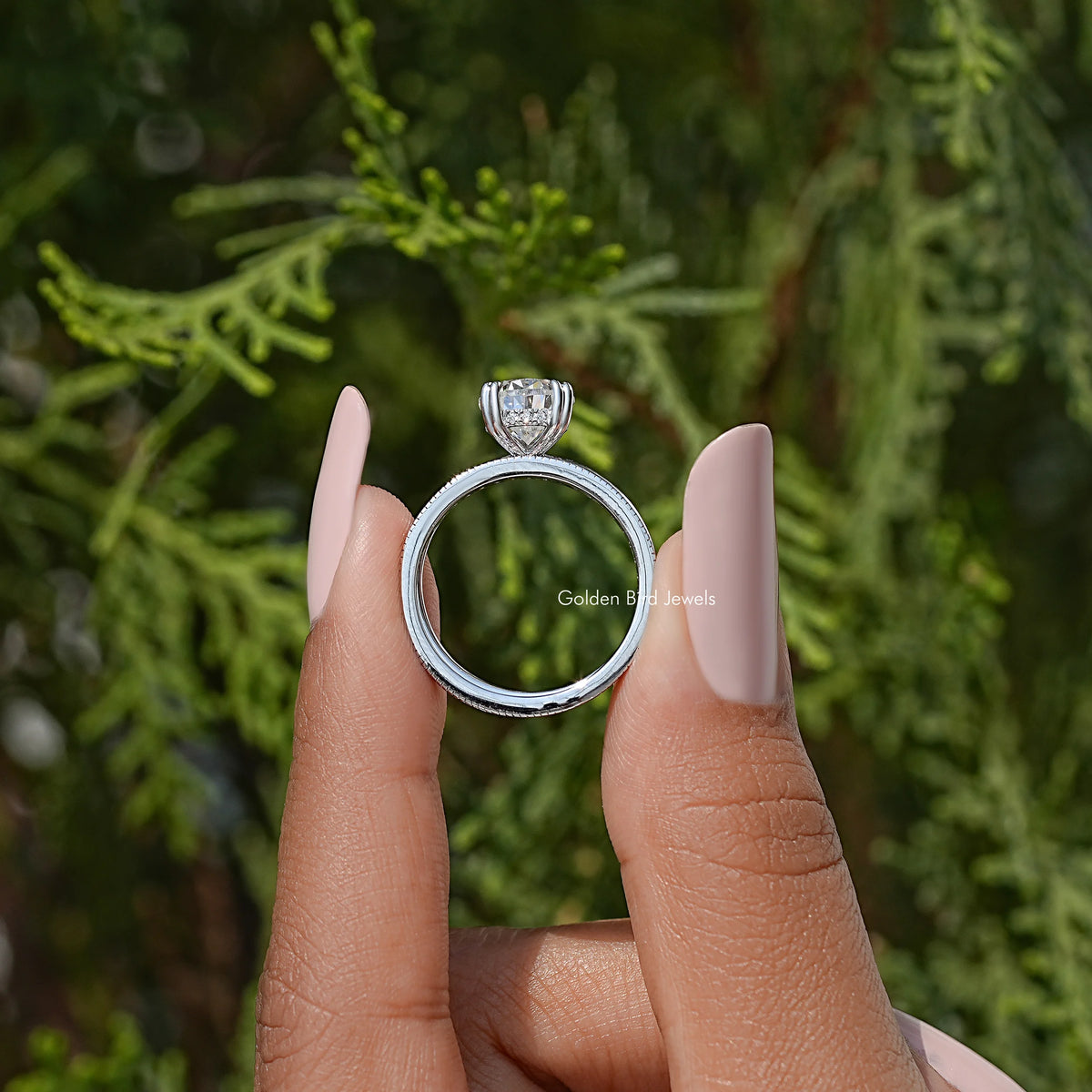 Pear moissanite ring with hidden halo and pavé eternity band, side view