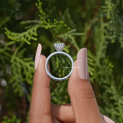 Pear moissanite ring with hidden halo and pavé eternity band, side view