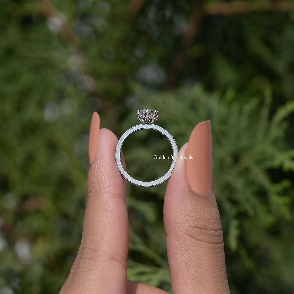 Marquise-cut moissanite ring from below, silver band, setting visible