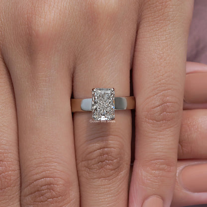 Square-cut diamond engagement ring with silver band on two fingers