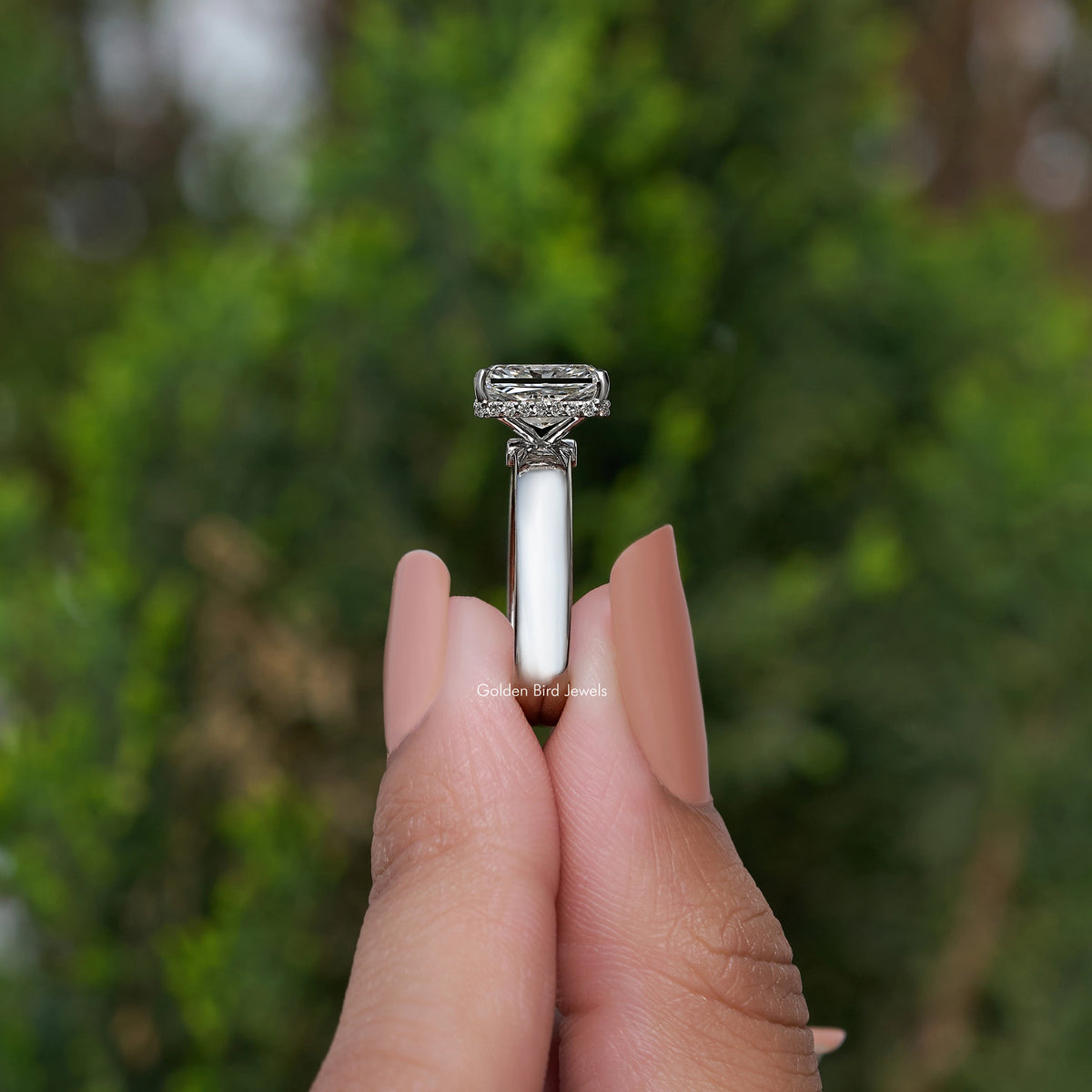 Side view of square-cut diamond ring showing silver prongs and band