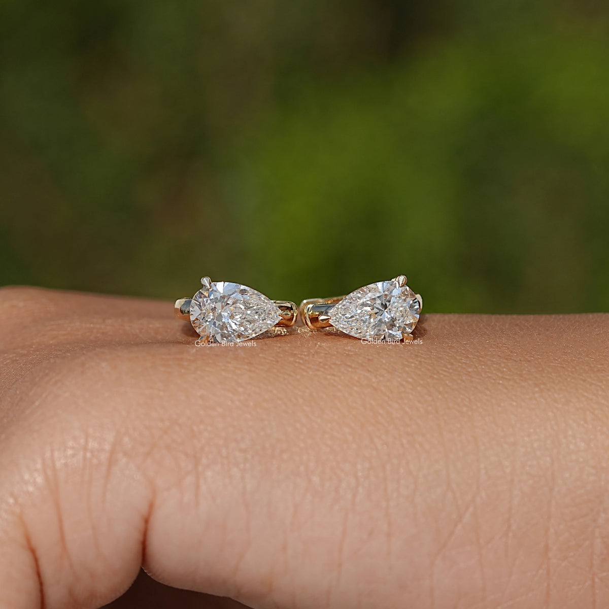 Gold huggie hoop earrings with two pear-cut lab diamonds