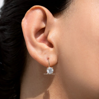 Gold-tone round lab-grown diamond drop earring detail on ear