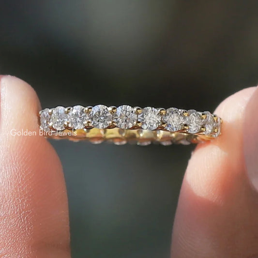 Silver-tone eternity band ring with round-cut clear stones across the full band