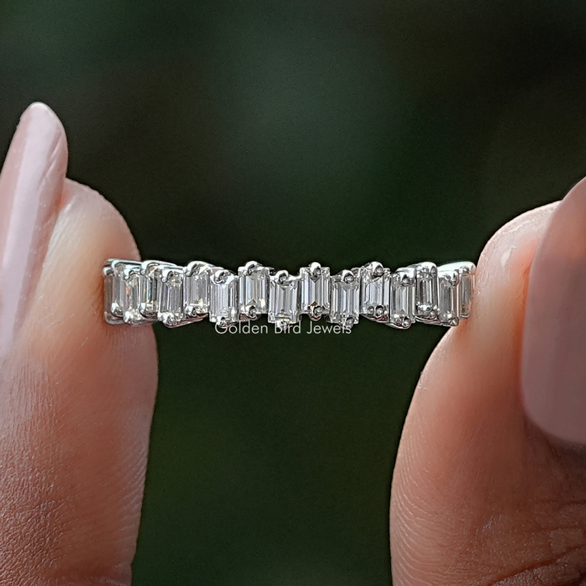 Silver half eternity band with baguette-cut stones along the top half